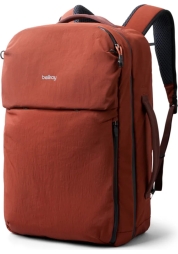 Meet the Lite Travel Pack Rucksack 30L clay, the perfect hybrid of a backpack and suitcase. With its lightweight nylon construction and ample storage space, it's ideal for traveling. Its unique design allows the backpack to simply "strap" onto the handle of a suitcase, ensuring hassle-free portability.