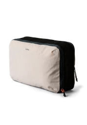 Enjoy your travels with the Lite Packing Cube 12L - a sleek travel suitcase organizer. This exceptional storage module offers up to 12 liters of capacity for your pants, toiletries and more, and is available in a variety of colors. It is easily compressible and expandable, giving you maximum packing flexibility.